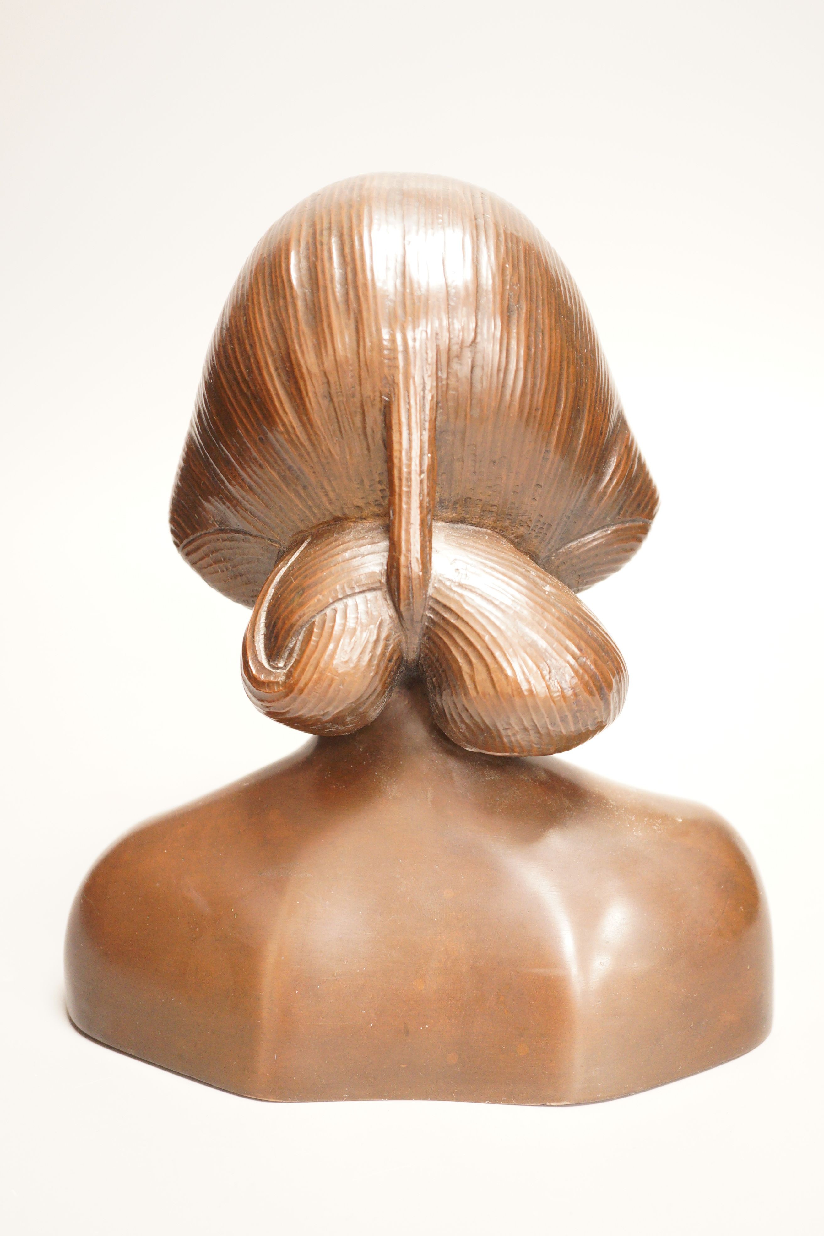 A 20th century bronze shoulder length bust, study of an Oriental lady, probably Balinese, 21cm